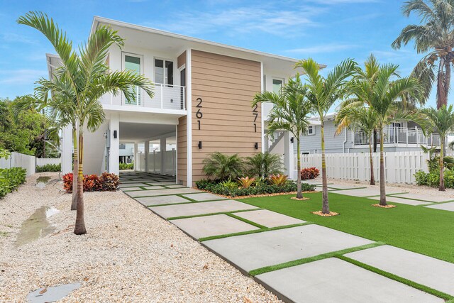 view of front of house with a carport and a balcony