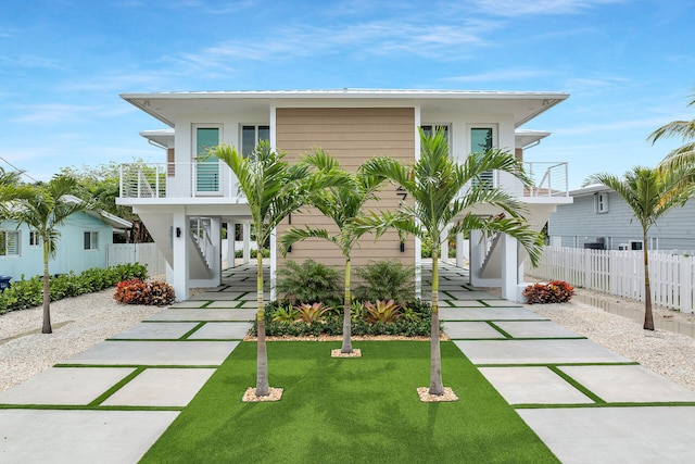 coastal inspired home featuring a carport and a balcony