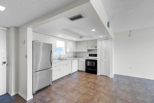 kitchen with range with electric cooktop, sink, white cabinets, stainless steel fridge, and a textured ceiling