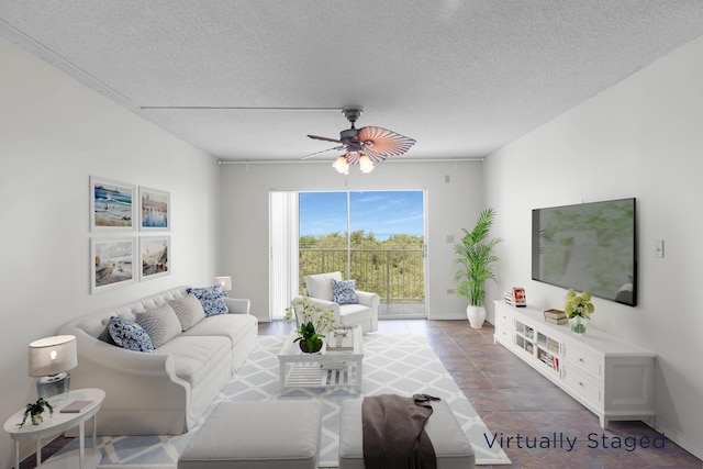 living room with ceiling fan and a textured ceiling