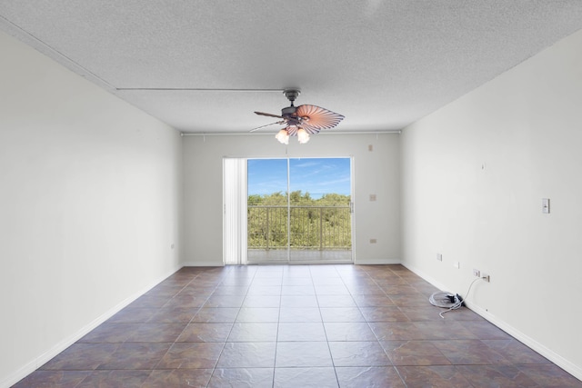 empty room featuring ceiling fan and a textured ceiling