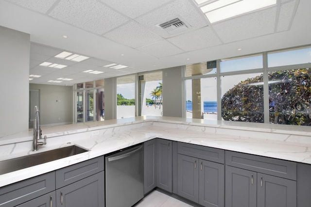 kitchen with sink, gray cabinets, a water view, light stone counters, and stainless steel dishwasher