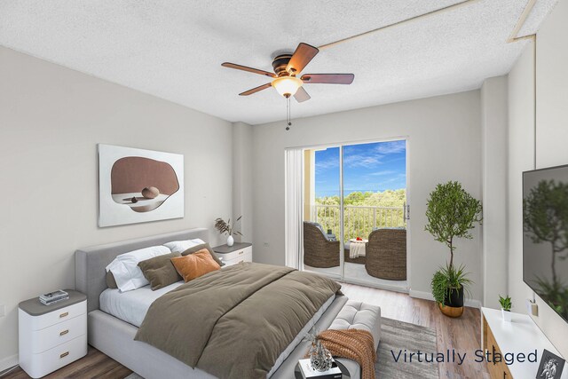 bedroom featuring ceiling fan, hardwood / wood-style floors, a textured ceiling, and access to outside