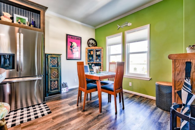 dining area featuring ornamental molding, wood finished floors, and baseboards