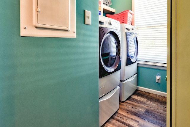 laundry room featuring laundry area, dark wood-type flooring, washer and dryer, and baseboards