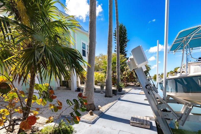 view of patio / terrace with a dock and boat lift