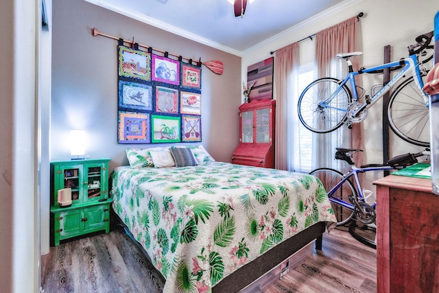 bedroom featuring ceiling fan, ornamental molding, and wood finished floors