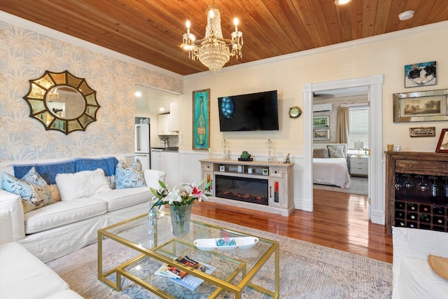 1030 James St, Key West, FL 33040 - living area with wallpapered walls, ornamental molding, a chandelier, wood finished floors, and wood ceiling