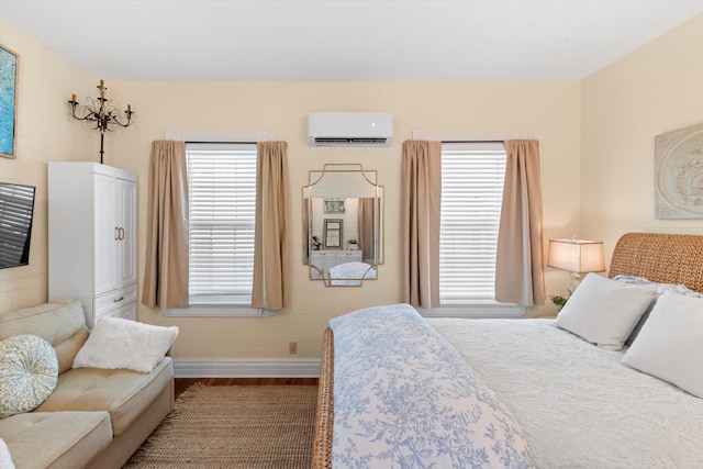 1030 James St, Key West, FL 33040 - bedroom featuring a wall mounted air conditioner, baseboards, and wood finished floors