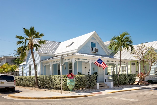1030 James St, Key West, FL 33040 - view of front of house featuring a porch, metal roof, and cooling unit