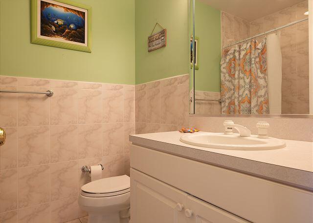 bathroom with tile walls, vanity, a shower with curtain, and toilet