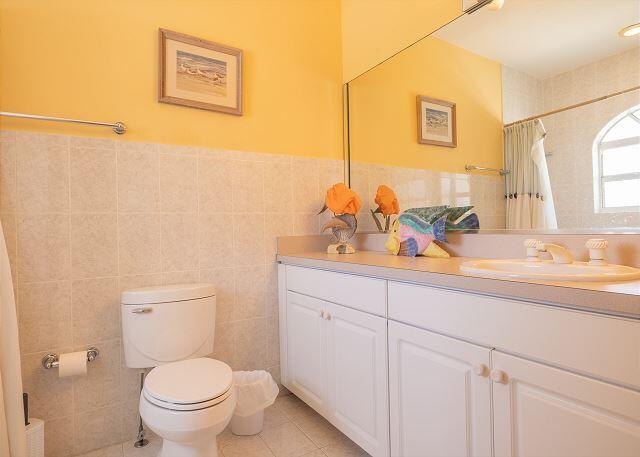 bathroom with tile walls, vanity, toilet, tile patterned floors, and a shower with shower curtain