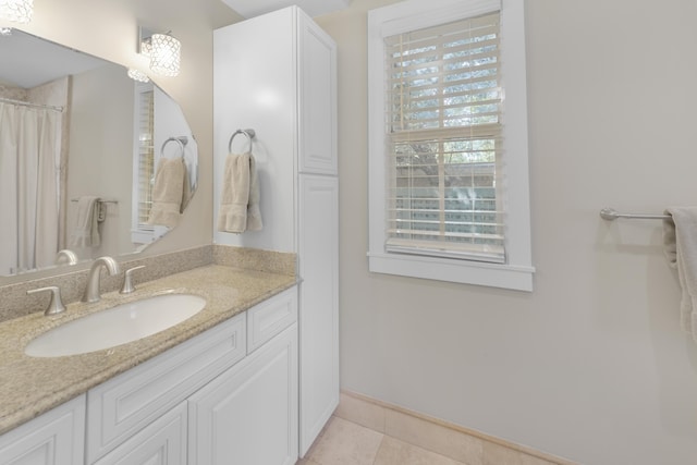 bathroom featuring walk in shower, vanity, and tile patterned flooring