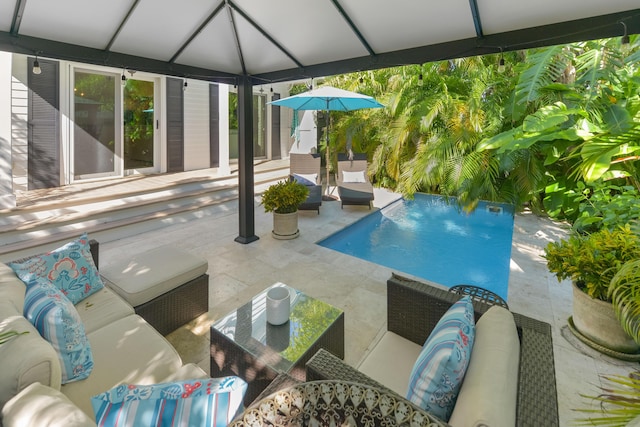 view of pool with an outdoor living space and a patio