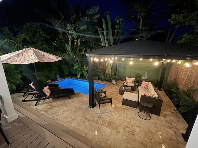 pool at twilight featuring an outdoor hangout area and a patio