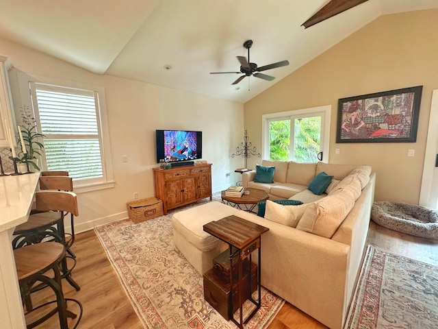 living room with vaulted ceiling, ceiling fan, and light hardwood / wood-style floors