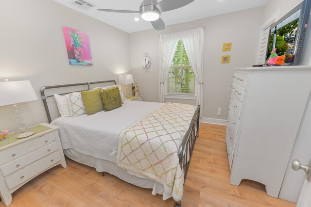 bedroom with light hardwood / wood-style flooring and ceiling fan