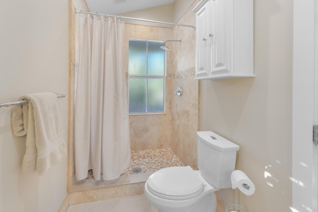 bathroom featuring toilet and a shower with shower curtain