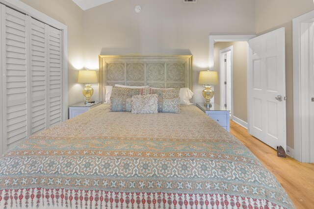 bedroom featuring light hardwood / wood-style flooring and vaulted ceiling