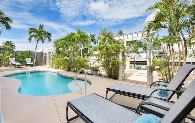 view of swimming pool featuring a pergola and a patio