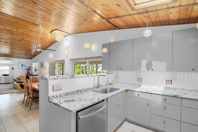 kitchen featuring decorative light fixtures, dishwasher, sink, kitchen peninsula, and light stone countertops