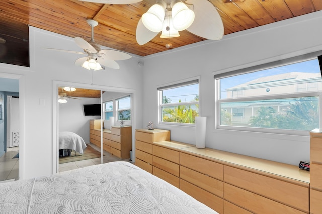 tiled bedroom featuring wooden ceiling and ceiling fan