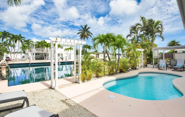 view of swimming pool featuring a pergola and a patio