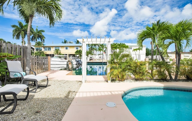 view of swimming pool featuring a patio area and a pergola