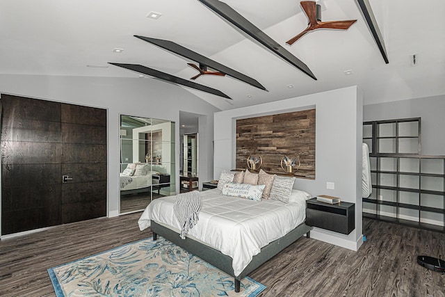 bedroom featuring vaulted ceiling with beams, dark hardwood / wood-style floors, and ceiling fan