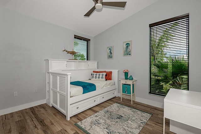 bedroom featuring hardwood / wood-style flooring, lofted ceiling, and ceiling fan