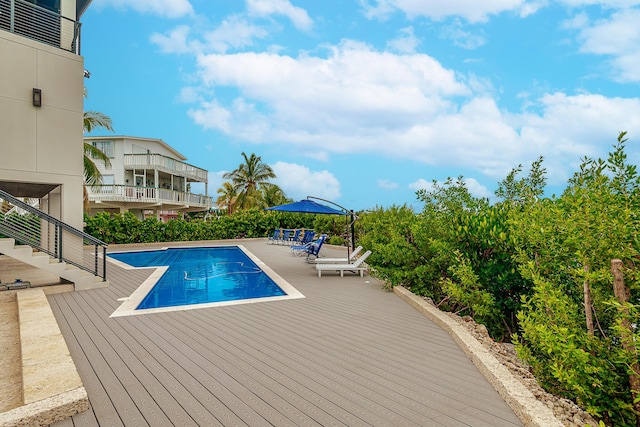 view of swimming pool with a deck