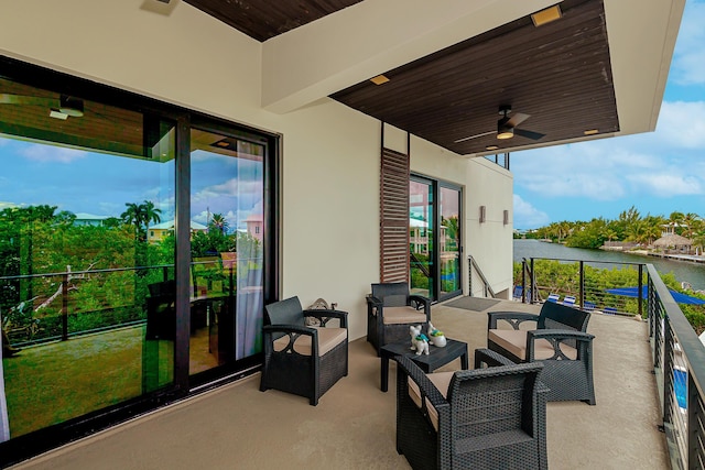 view of patio featuring a balcony, a water view, and ceiling fan