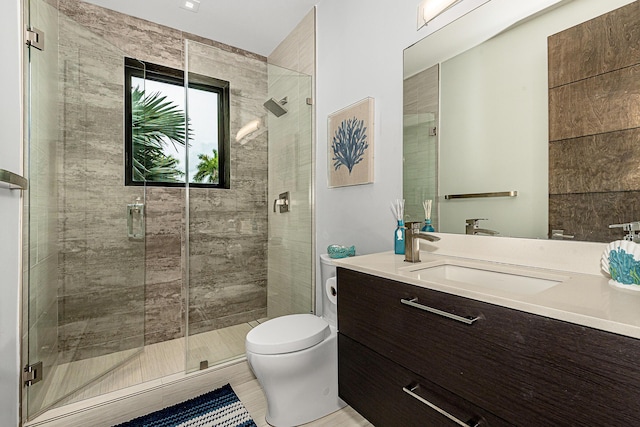 bathroom with vanity, toilet, and an enclosed shower