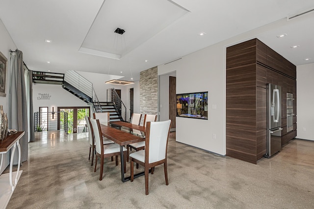 dining area with a high ceiling and a tray ceiling