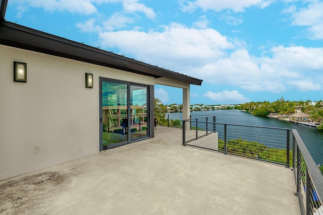 view of patio / terrace with a balcony and a water view