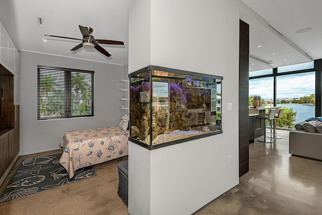 interior space featuring concrete flooring and ceiling fan