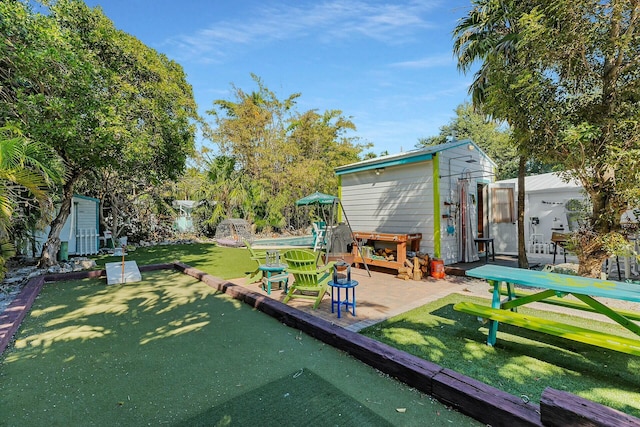 view of yard with a patio and a shed