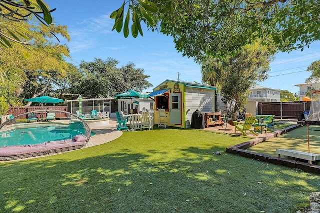 exterior space featuring a lawn and a storage unit