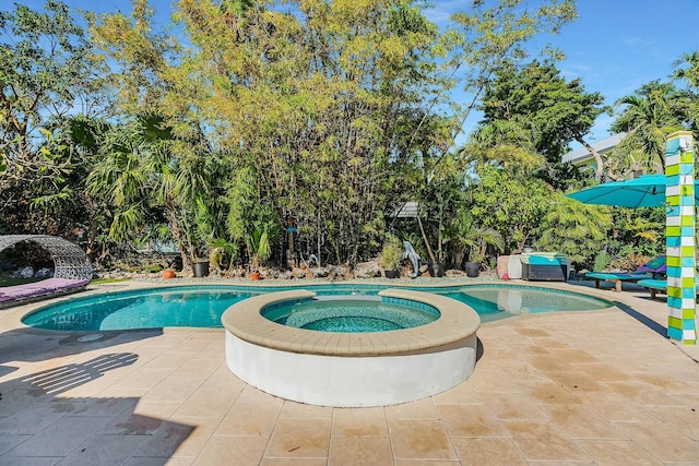 view of swimming pool featuring a patio and an in ground hot tub