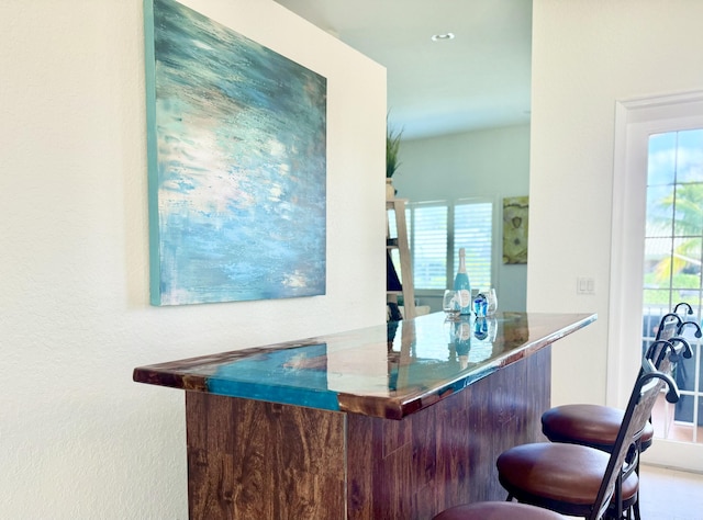 bar featuring a wealth of natural light