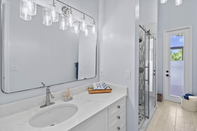 bathroom with a stall shower and vanity