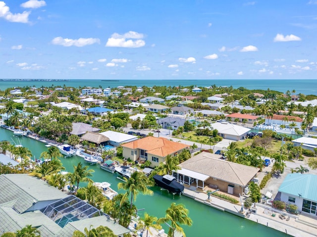 birds eye view of property featuring a water view and a residential view