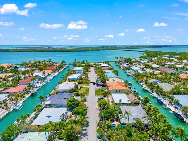 birds eye view of property with a water view and a residential view