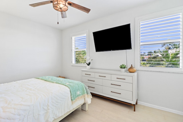bedroom with baseboards and ceiling fan