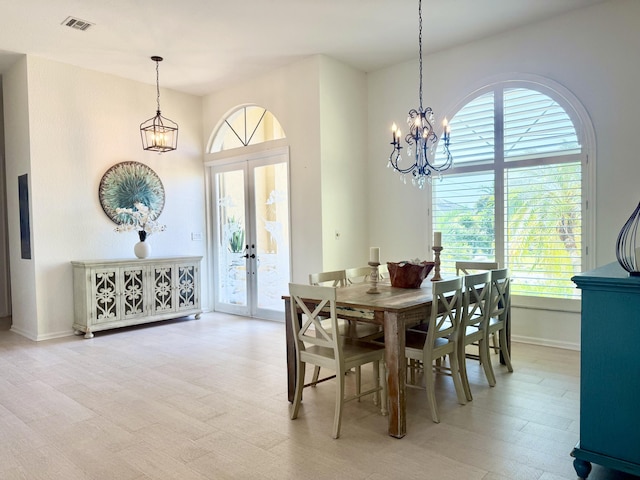 dining room with french doors, a healthy amount of sunlight, a chandelier, and visible vents