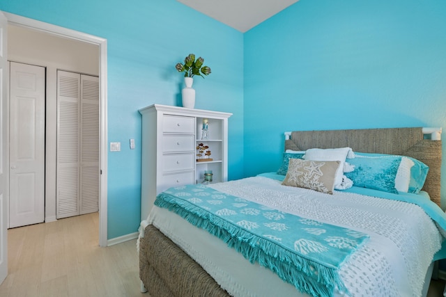 bedroom with wood finished floors and baseboards