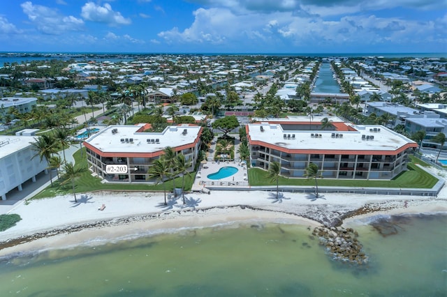 drone / aerial view featuring a view of the beach and a water view