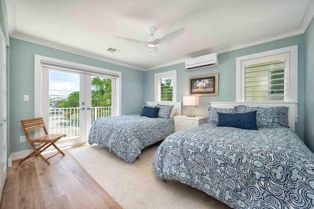 bedroom featuring crown molding, access to outside, french doors, and a wall mounted AC