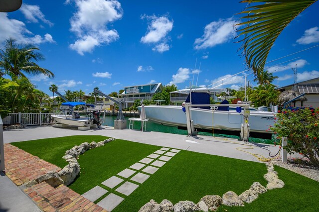 view of yard with a boat dock and a water view