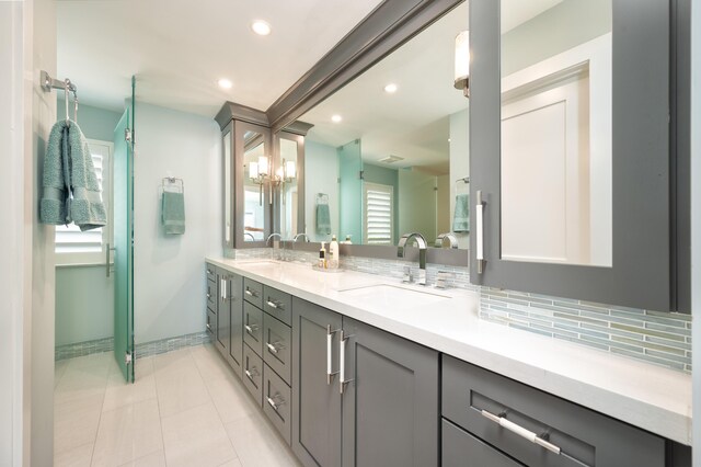 bathroom featuring vanity, tasteful backsplash, and tile patterned floors